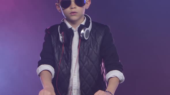 Teenager Dj in Leather Jacket Mixes Music on Smoky Background