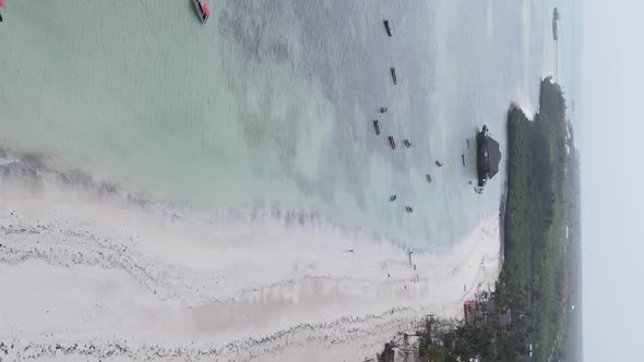 Vertical Video Boats in the Ocean Near the Coast of Zanzibar Tanzania Aerial View