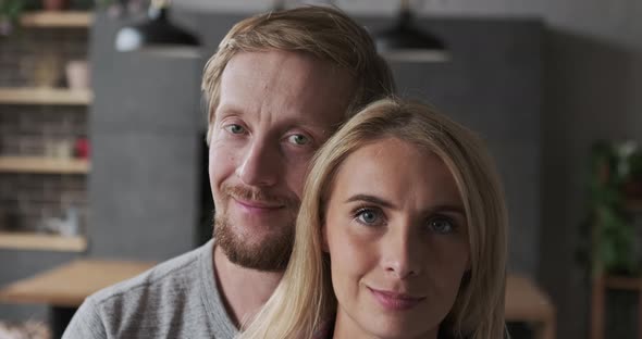 Enamored Husband and Wife Embracing Taking Care Support with Best Love Feeling at Luxury Apartment