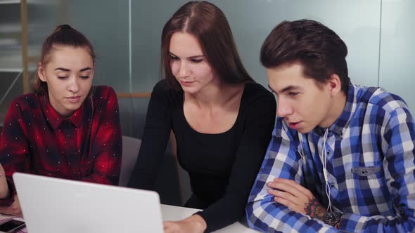 Creative Business Team of Three People Working at the Laptop in a Modern Office