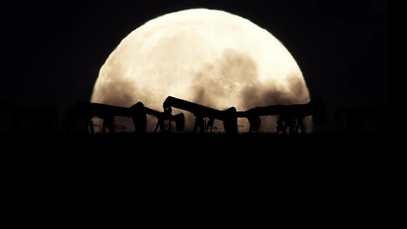 Oil Pumps On A Full Moon Background In A Polluted Environment