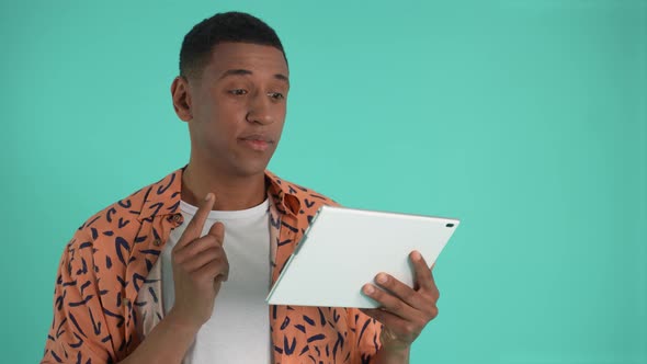 Pensive African American Man Using Tablet