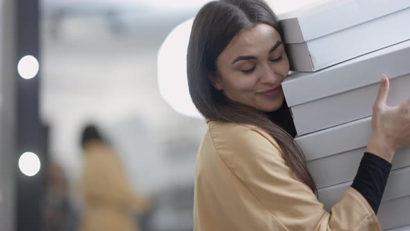 Portrait of Happy Excited Caucasian Young Beautiful Woman Holding Lot Boxes with Clothes Shoes