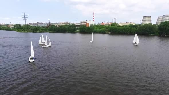 Aerial view of Boats on the city pond with industrial landscape