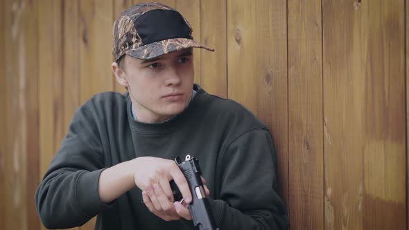 Young Minor Man with a Pistol