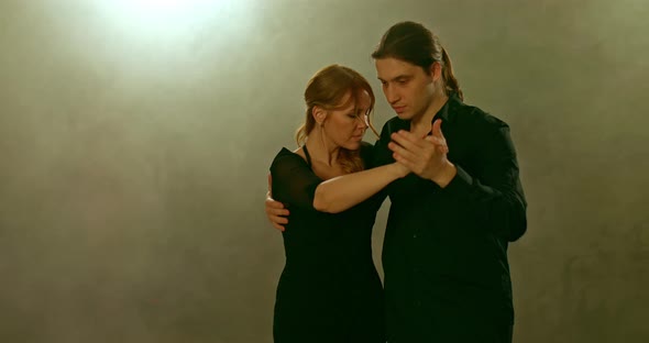 Passionate Couple of Dancers Dancing in Smoke Tango
