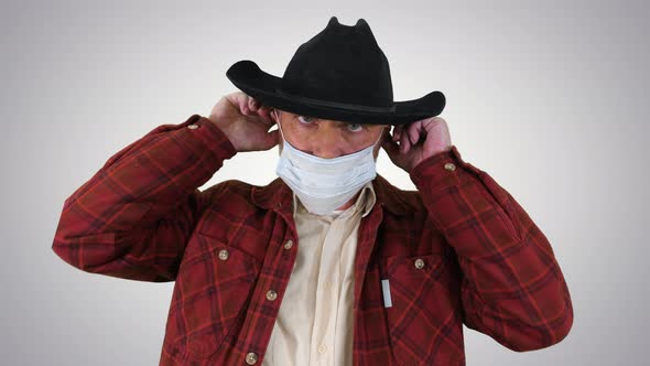 Cowboy Wears Medical Mask To Prevent Corona Virus on Gradient Background