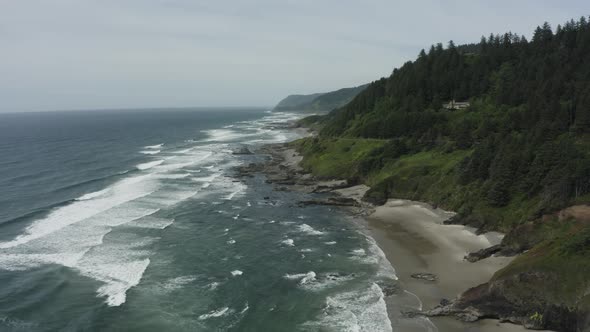 Slowly rising drone shot of rocky Oregon sea cliffs