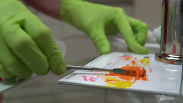 Closeup View of Woman's Hands in Gloves Preparing Medicine and Resources for Dental Treatment