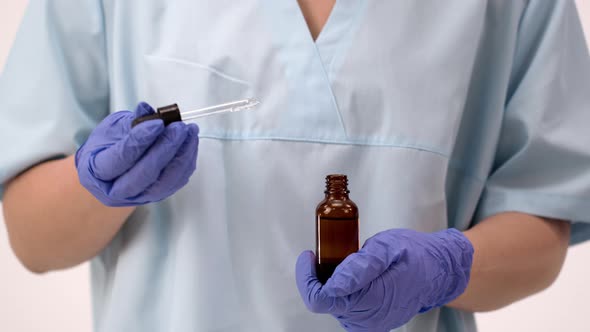 Doctor in Sterile Gloves Holds in His Hands a Medicine or Vaccine for Covid 19.