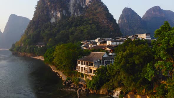 Waterfront buildings at the foot of karst mountain on the banks of Li river, Yangshuo, China
