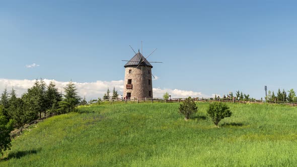 Historical Stone Windmill And People