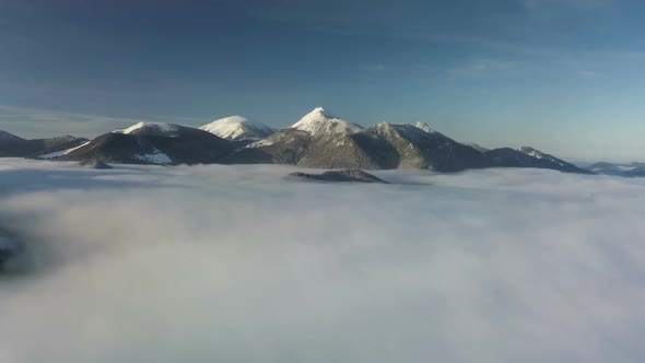 Winter Mountains above Misty Clouds