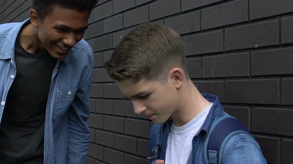 Afro-American Teenager Laughing at Caucasian Student, Social Problem, Bullying