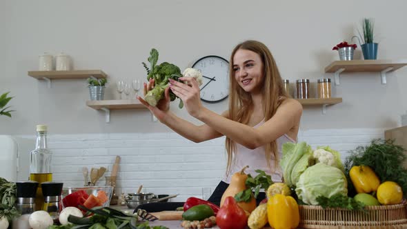 Girl Recommending Eating Raw Vegetable Food. Showing Broccoli and Cauliflower. Weight Loss, Diet