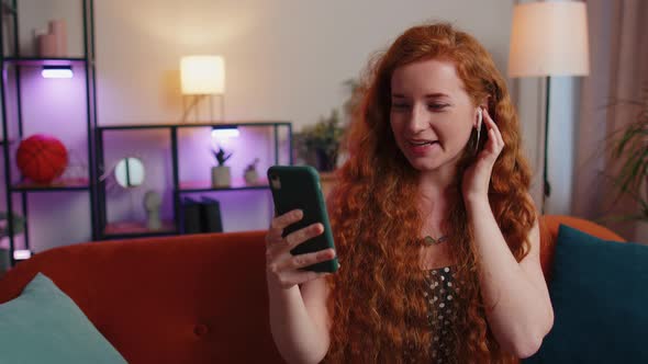Red Hair Woman Enjoying Smartphone Call Talking Mobile Phone Conversation with Friends at Home