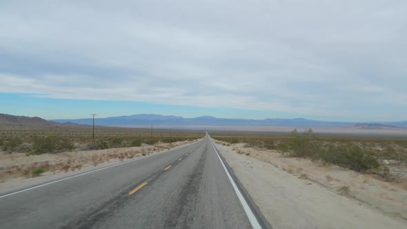 Driving Shot On An Empty Road In Desert Valley, Slow Motion 