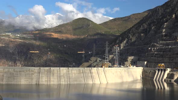 Arch Dam Full of Water in Mountains