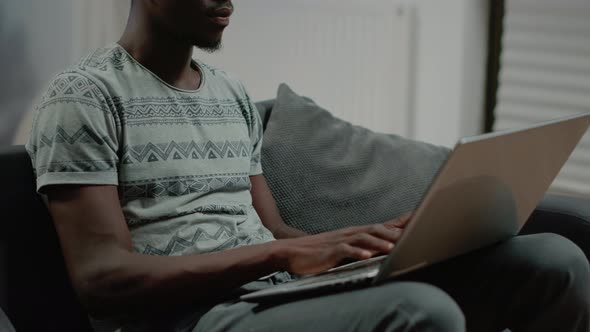 Close Up of Black Person Typing on Laptop Keyboard