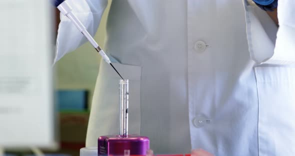 Scientist using pipette  alt