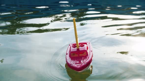 A Toy Ship Sailing in the Pool