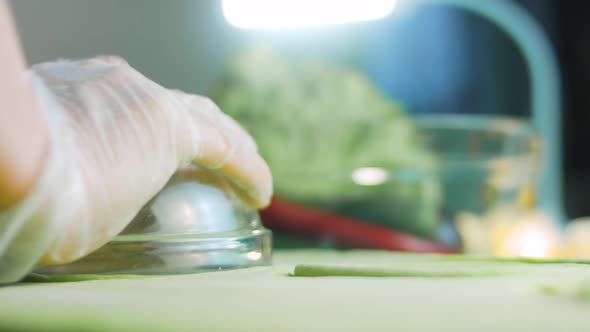 The Chef Forms Round Dough From the Green Dough with a Transparent Bowl