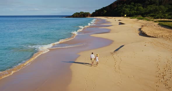 Happy Retired Couple Walking Down the Beach