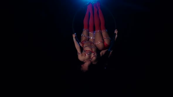 Two Women i Swing in the Hoop. Black Background. Slow Motion