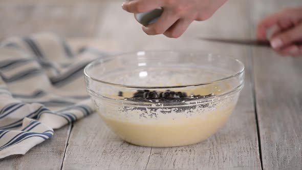 Add Blueberries To the Batter. Kneading Raw Dough in a Bowl