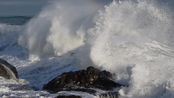 Rolling Waves Crashing To Rocky Shore