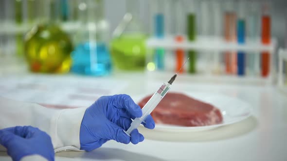 Scientist Injecting Liquid in Meat Sample Conducting Product Quality Analysis