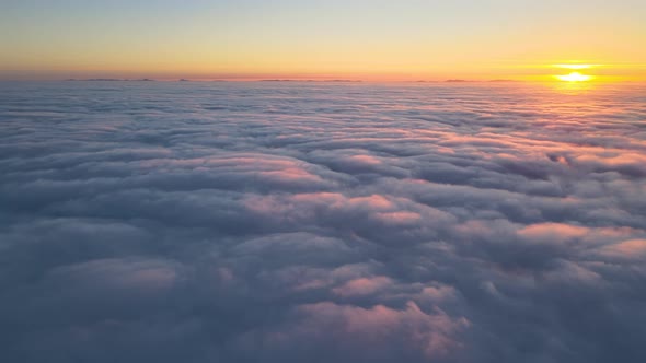 Aerial View From Above at High Altitude of Dense Puffy Cumulus Clouds Flying in Evening