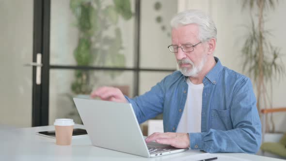 Senior Old Man Standing Up and Going Away While Using Laptop