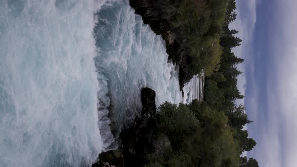 Vertical shot of water gushing through famous Huka falls, Taupo, New Zealand
