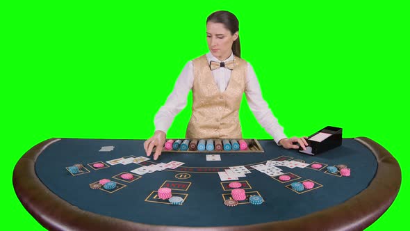 Casino Croupier Distributes for Table Poker Three Cards Are the Flop. Green Screen. Slow Motion