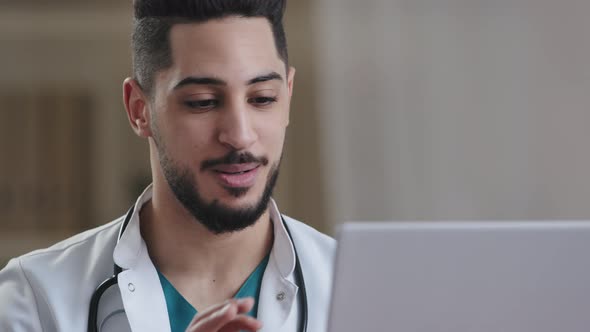 Young Male Hispanic Nurse Doctor Practitioner Arab Medical Adviser in White Coat Use Digital