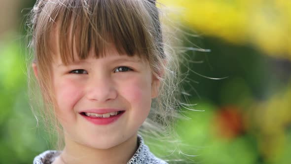 Portrait of Happy Smiling Child Girl Outdoors in Summer