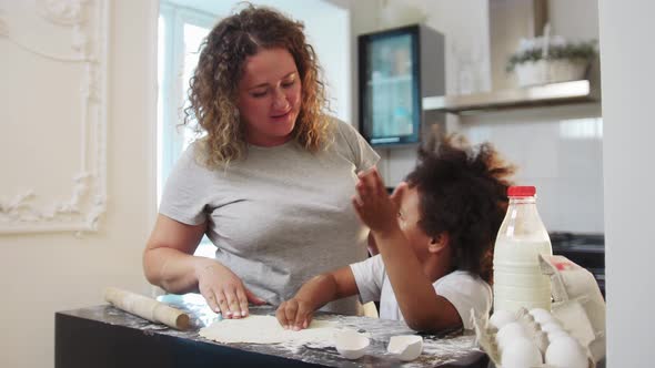 Mixed Family Baking  Black Little Girl and Her Mother Playing with Food