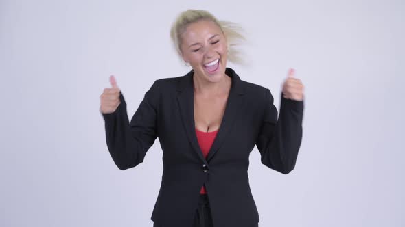 Young Happy Blonde Businesswoman Looking Excited and Giving Thumbs Up