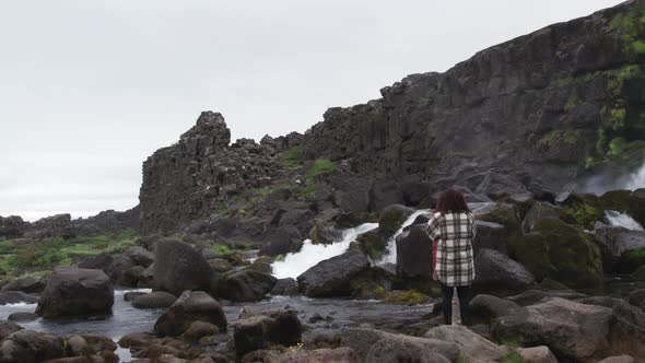 Couple With Camera By Oxararfoss Waterfall