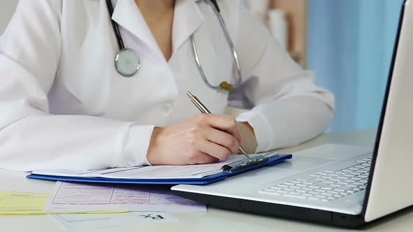 Woman Doctor Working in Office, Writing Down Medical Records, Filling Out Papers