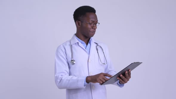 Young Happy African Man Doctor Reading on Clipboard and Giving Thumbs Up