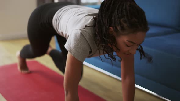 Young African American Female Athlete Working Out in the Living Room