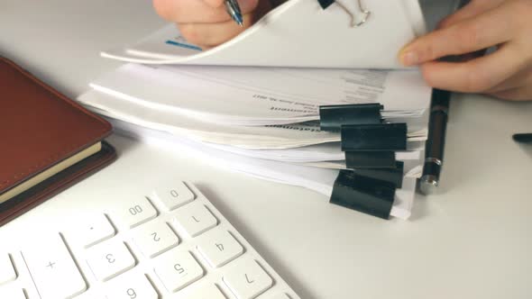 Top View of a Auditor or Businessman Checking Searching Document Legal for Prepare Paperwork or