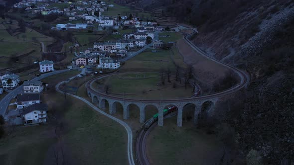 Train on Brusio Spiral Viaduct in Switzerland