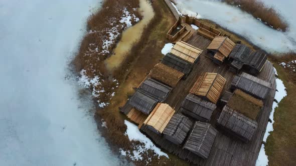 Historical Wooden Buildings on Small Island in the Frozen Lake Araisi in the Winter