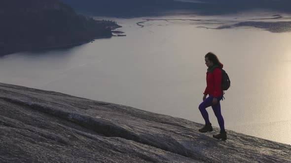 Adventurous Girl Hiking on Top of a Peak