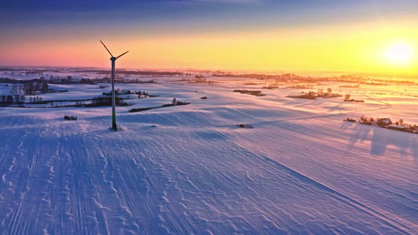 Winter field and wind turbine. Alternative energy. Aerial view, Poland