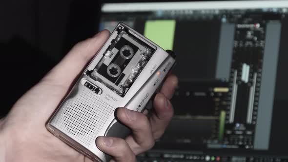 Portable Tape Recorder in Hand Records Sound or Interviews on a Mini Cassette