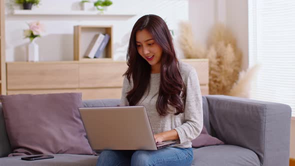 Entrepreneur of beautiful business asian young woman working online with laptop and celebrating at h